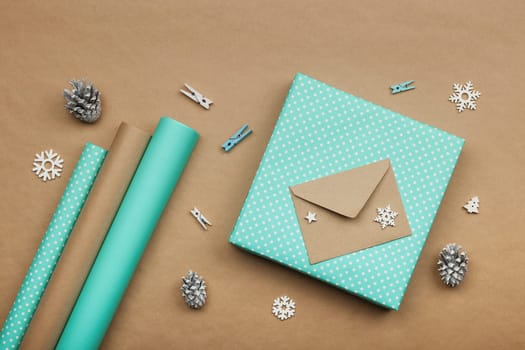 Packing Christmas gifts with blue paper
