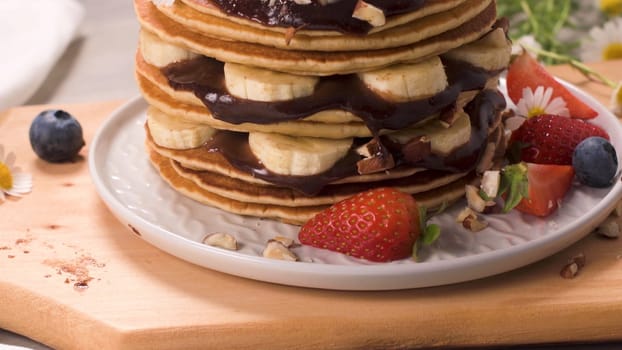 Pancakes with fruits and chocolate sauce