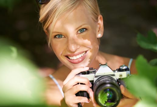 Portrait, photographer and camera lens with woman in forest for trees, environment and relax. Shooting, nature and photography with face of female person in woods for travel, tourism and summer