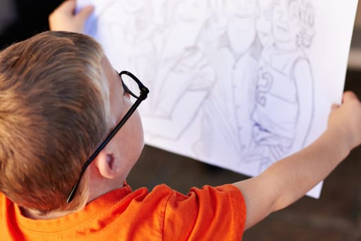 Talent, boy and student with a sketch, drawing and creativity with inspiration, artistic and thinking. Person, kid and model with glasses, childhood and development with education, skills and paper