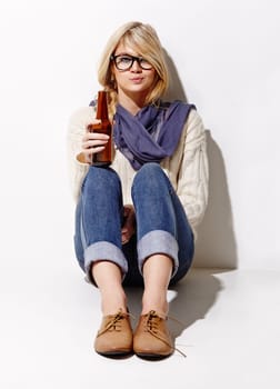 Portrait, beer and a bottle with a woman drinking in studio on a mockup white background. Party, event or alcohol with a young drunk girl enjoying a glass beverage for celebration or to relax.