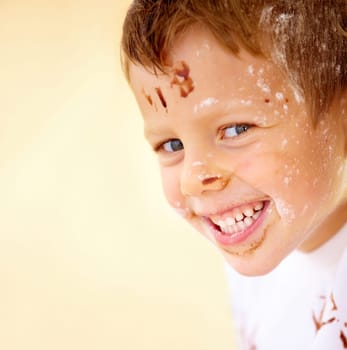 Portrait, happy and flour with a boy in the kitchen of his home, learning how to bake for child development. Children, smile and cooking with a young kid looking naughty with ingredients on his face