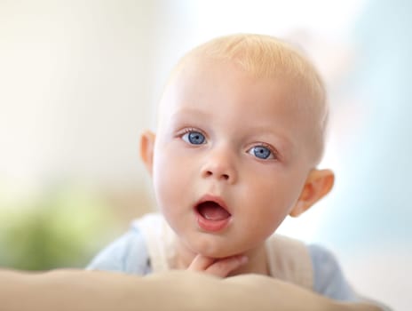 Baby, portrait or mouth curious in home for childhood development, safety or growth health. Boy, hand or face or discover support for alert play or youth learning or protection, comfort care in house.