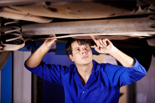 Car, inspection or service with an engineer man in a garage for a report on a vehicle repair for insurance. Maintenance, professional and expertise with a young mechanic in a workshop for assessment