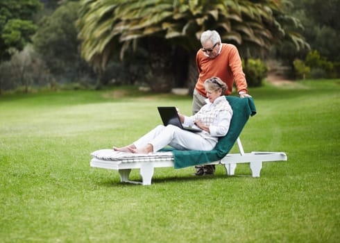 Love, relax and senior couple with laptop in garden for internet, search or communication while bonding. Social media, computer and old people chilling in backyard with online streaming subscription.