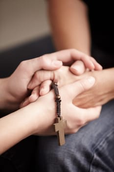 Helping hand, prayer together with beads and worship for religion, trust or spiritual hope. Support, counseling and people in Christian meeting for faith, praise or empathy with rosary, cross and God