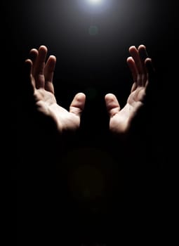 Hands, prayer and help from God with praise, closeup of holy person with gratitude and respect for religion. Guide, wellness and praying, worship and faith with hope and trust on dark background