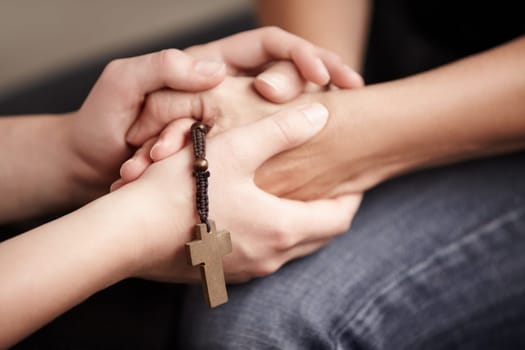 Holding hands, prayer together with beads and help for religion, trust and spiritual hope. Support, counseling and people in Christian meeting for faith, worship or empathy with rosary, cross and God