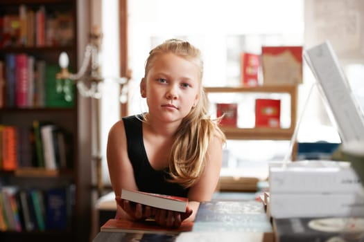 Girl kid in portrait, book and education, story for knowledge or entertainment with customer in bookshop. Library, store and learn for development and growth, fiction or literature with young child
