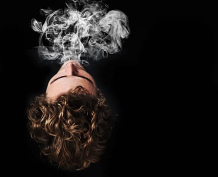 Man smoking marijuana, drugs or cigarette in studio isolated on black background mockup. Smoke, vape and person exhale cannabis, weed and addiction to tobacco, 420 cbd or substance abuse in top view