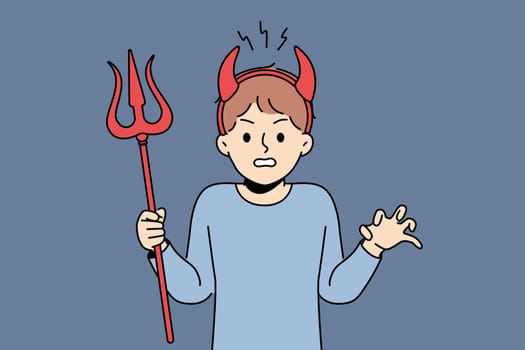 Little bully boy with devil horns makes evil grimace and terrorizes teachers at school