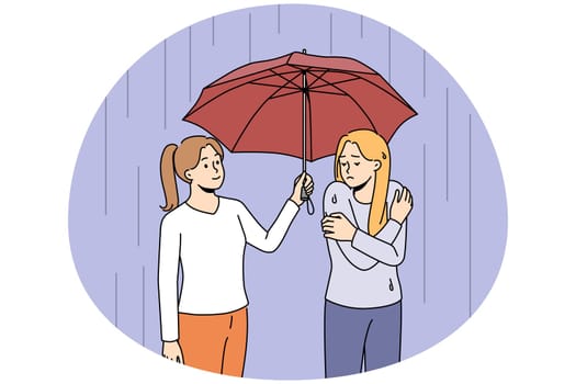 Caring woman share umbrella with friend