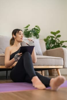 Exercise at home, Asian girl drinking water after workout fitness, Healthy asia woman training weight fit sport for body strength, Female exercising in home living room