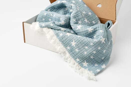 Blue cotton blanket in a box on white background