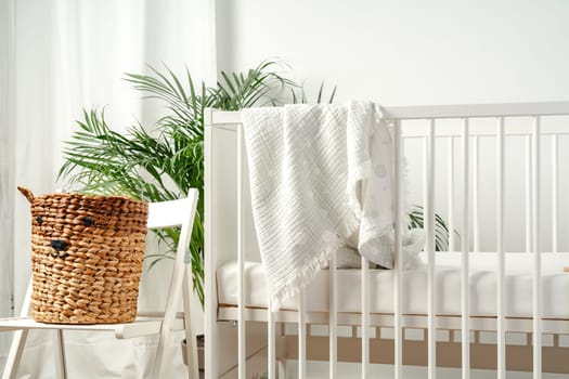 Baby bed and basket in nursery room interior