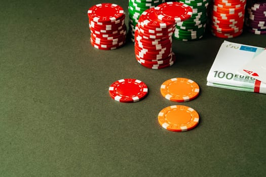 Poker chips and Euro banknotes on green background