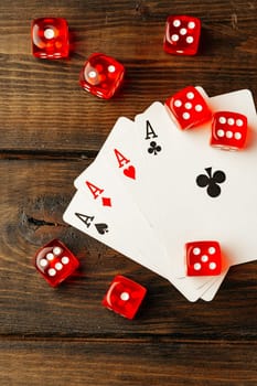Playing cards and dice cubes on wooden background
