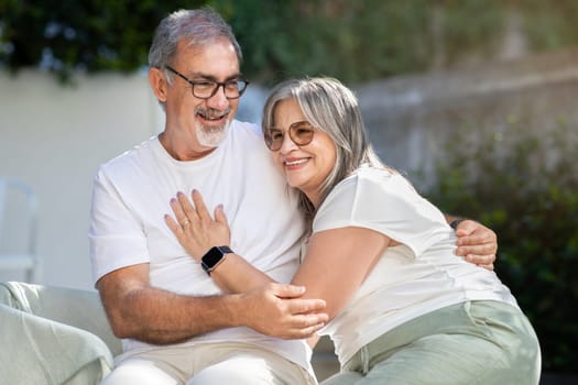 Smiling senior european husband and wife in white t-shirts have fun, enjoy spare time