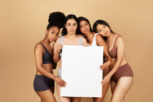Diverse women in underwear holding a blank sign placard board for design
