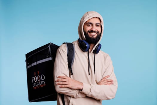 Arab man with backpack delivering food