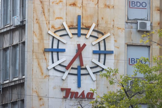 29 september 2023, Belgrade, Serbia - Wall clock - old stylish serbian construction, telephoto shot