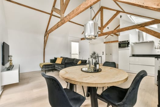 a living area with a round table and a kitchen