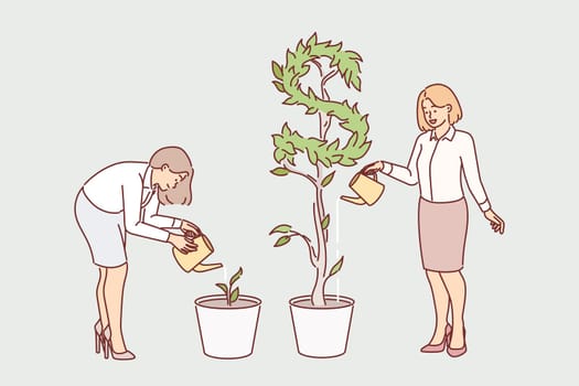 Business women watering plants getting different results in form of cash dividends from investments