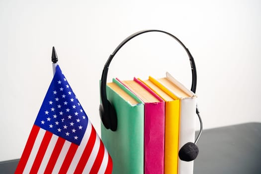 USA flag with pile of books against white background