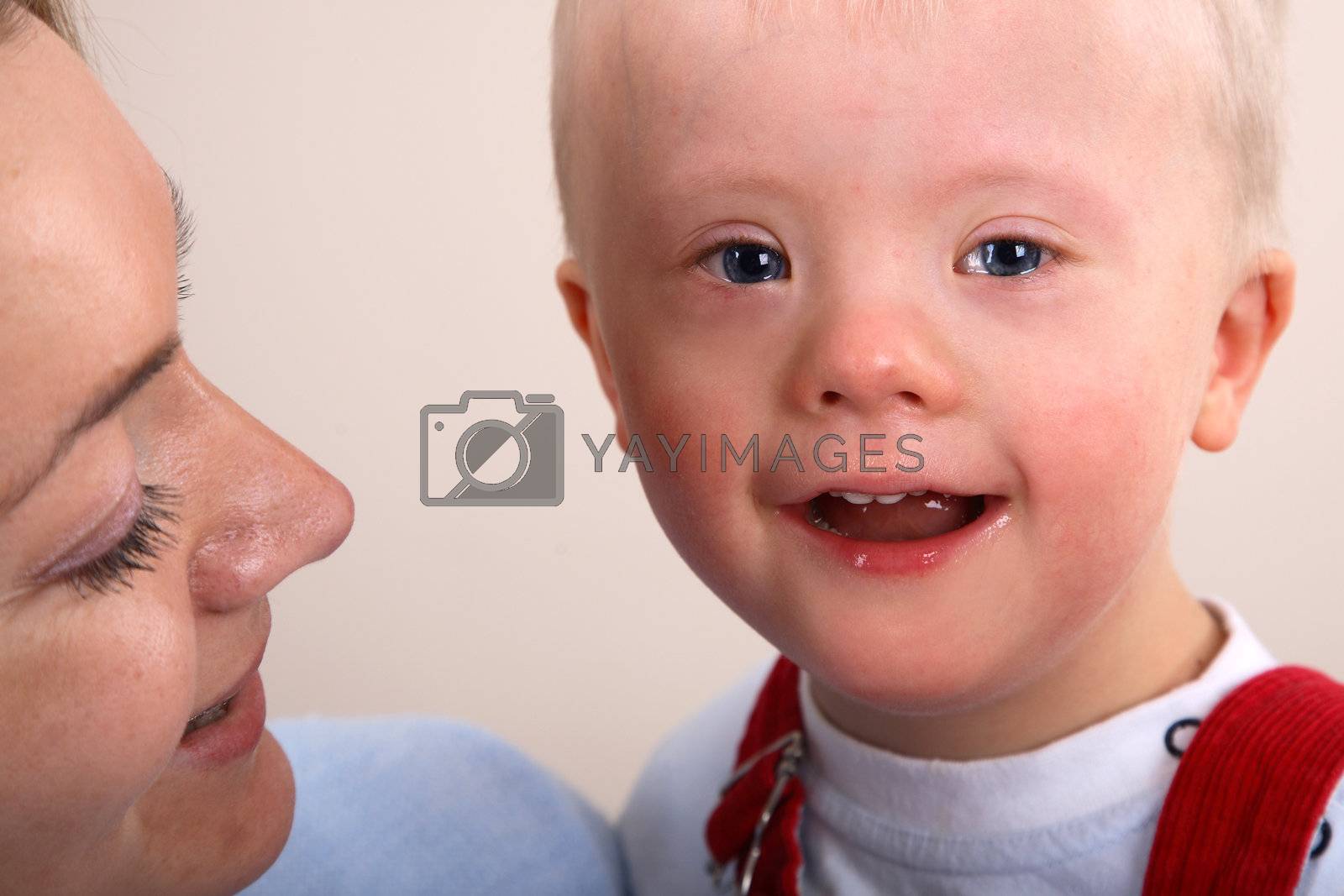 Royalty free image of Down Syndrome boy with mother by linea
