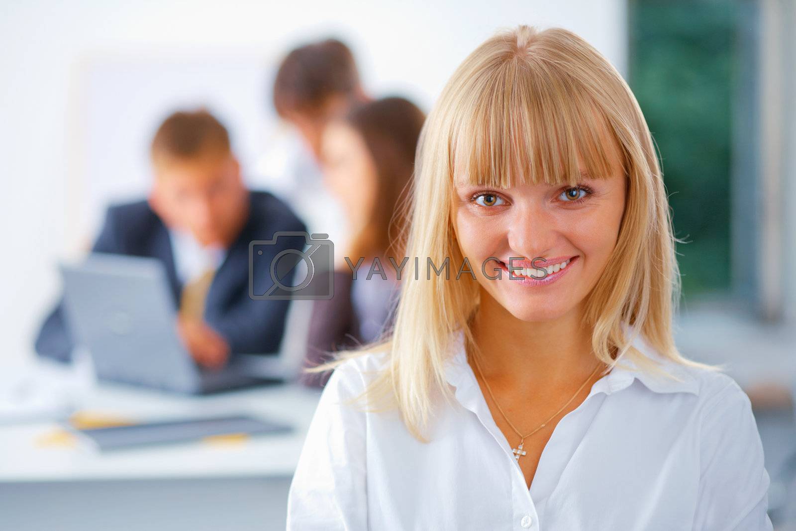 Royalty free image of Young happy business woman with her team by romanshyshak