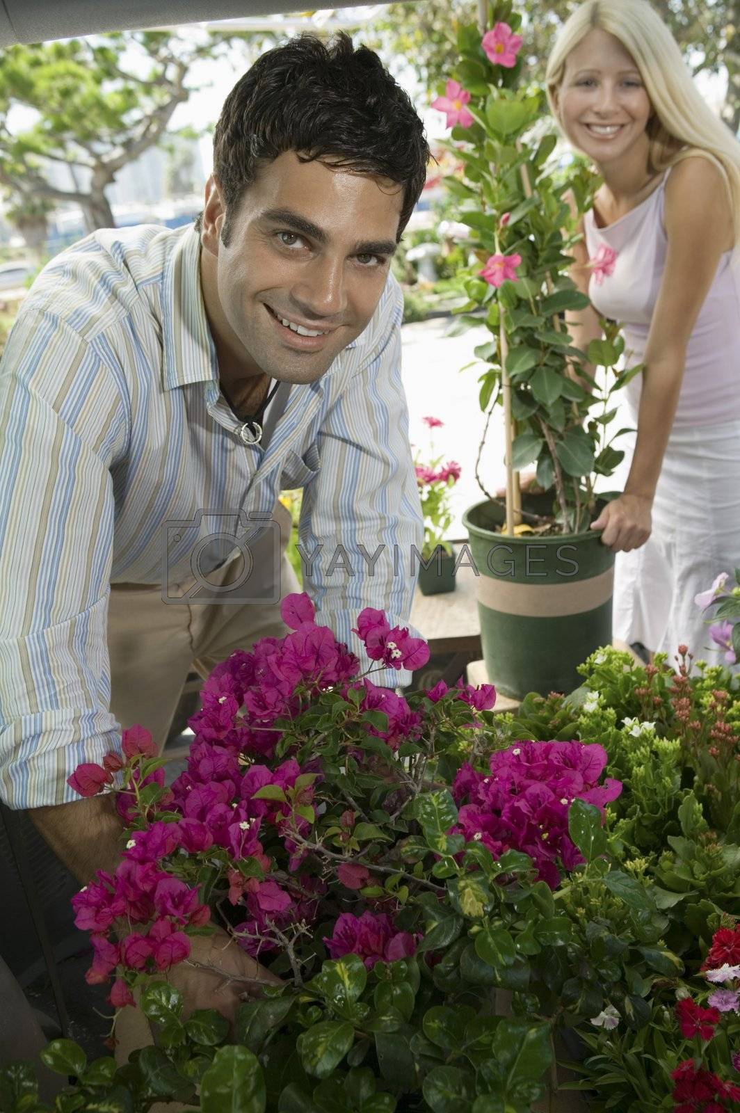 Royalty free image of Couple Selecting Plants by moodboard