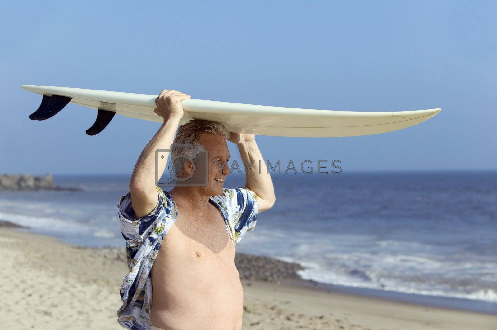 Royalty free image of Surfer Carrying Surfboard by moodboard