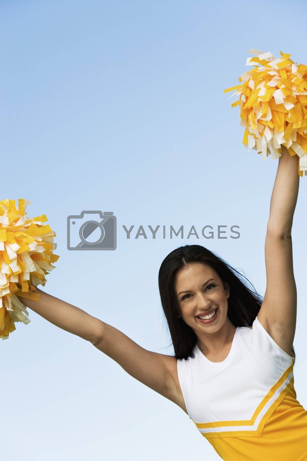 Royalty free image of Cheerleader Holding Pom-Poms by moodboard