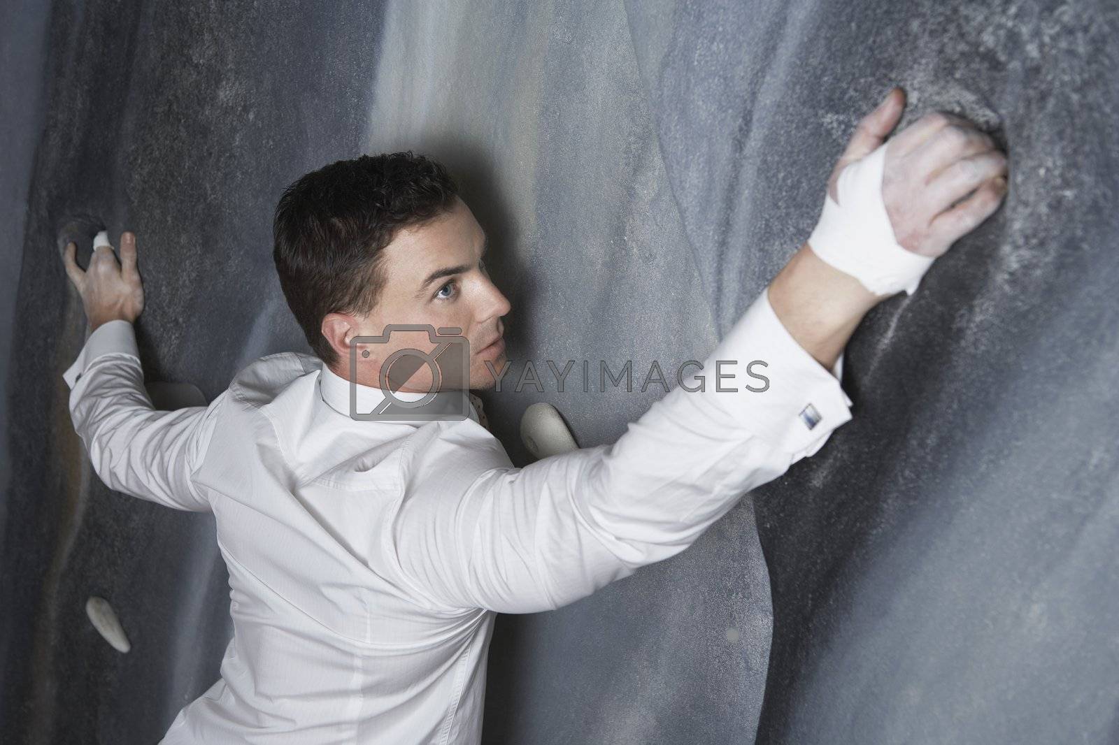 Royalty free image of Businessman Climbing Rock Wall by moodboard