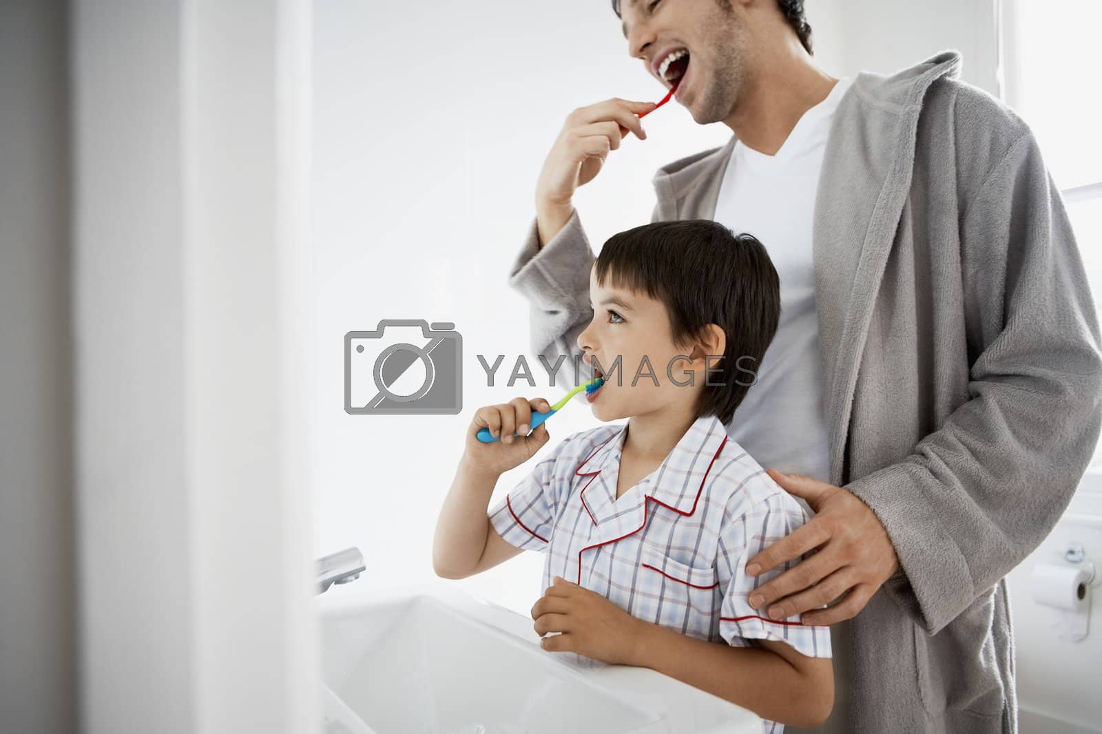 Royalty free image of Father and Son Brushing Teeth Together by moodboard