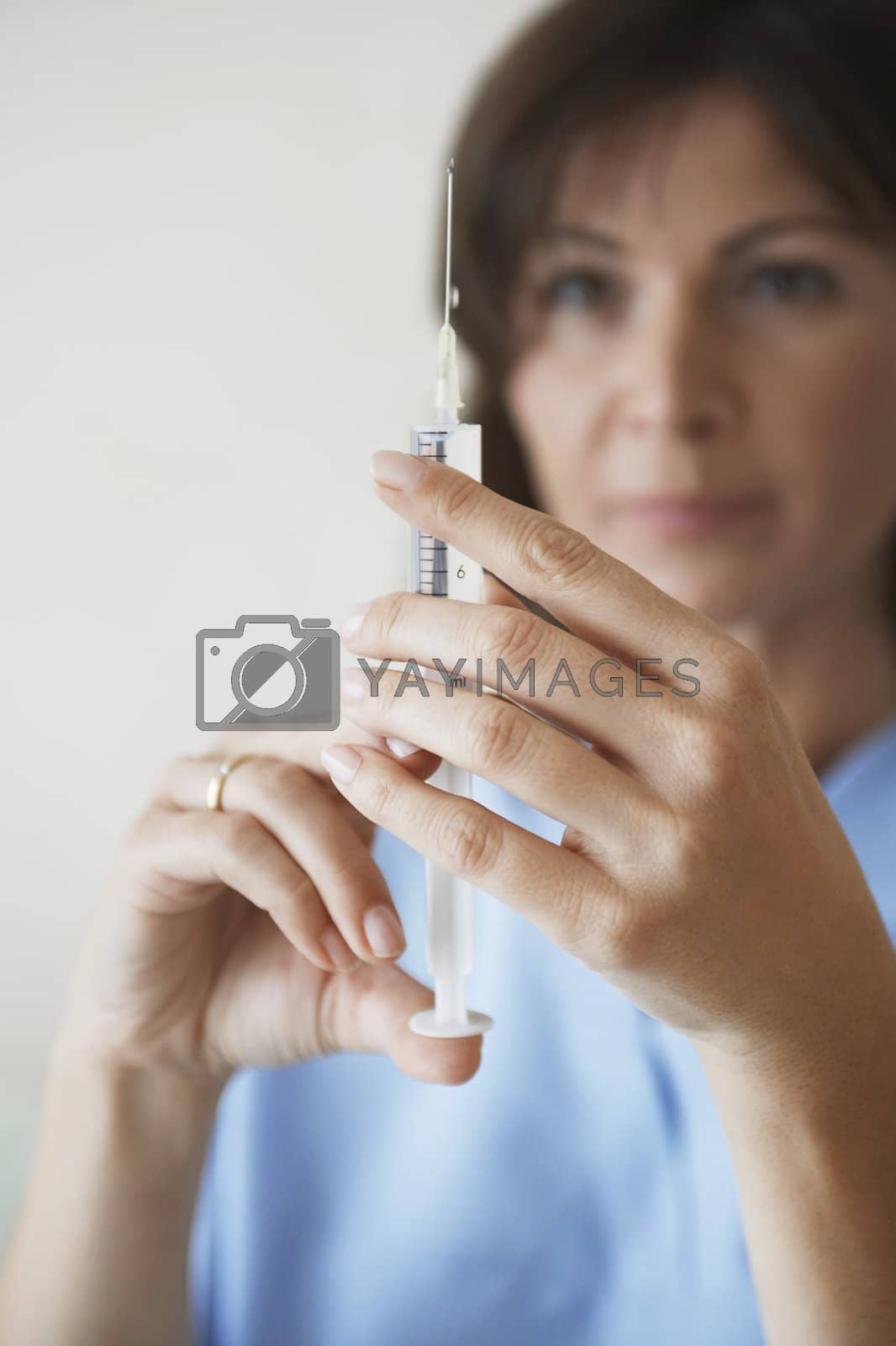 Royalty free image of Nurse Preparing Needle For Injection by moodboard