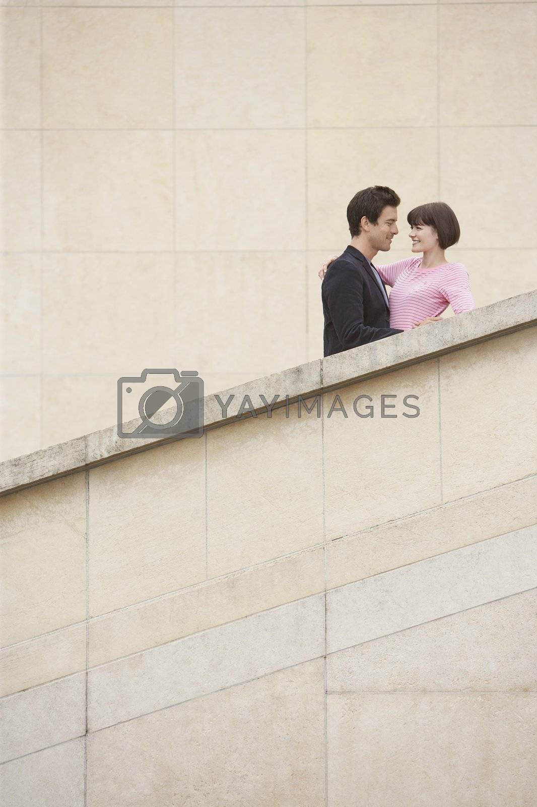 Royalty free image of Couple Embracing on Stairway by moodboard