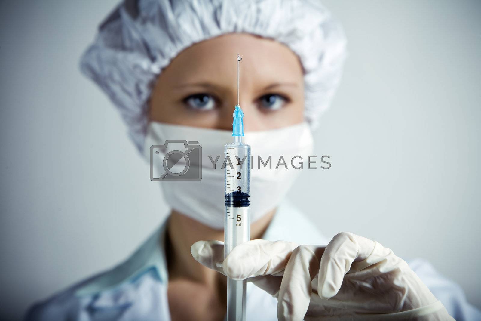 healthcare and medicine: nurse using a syringe