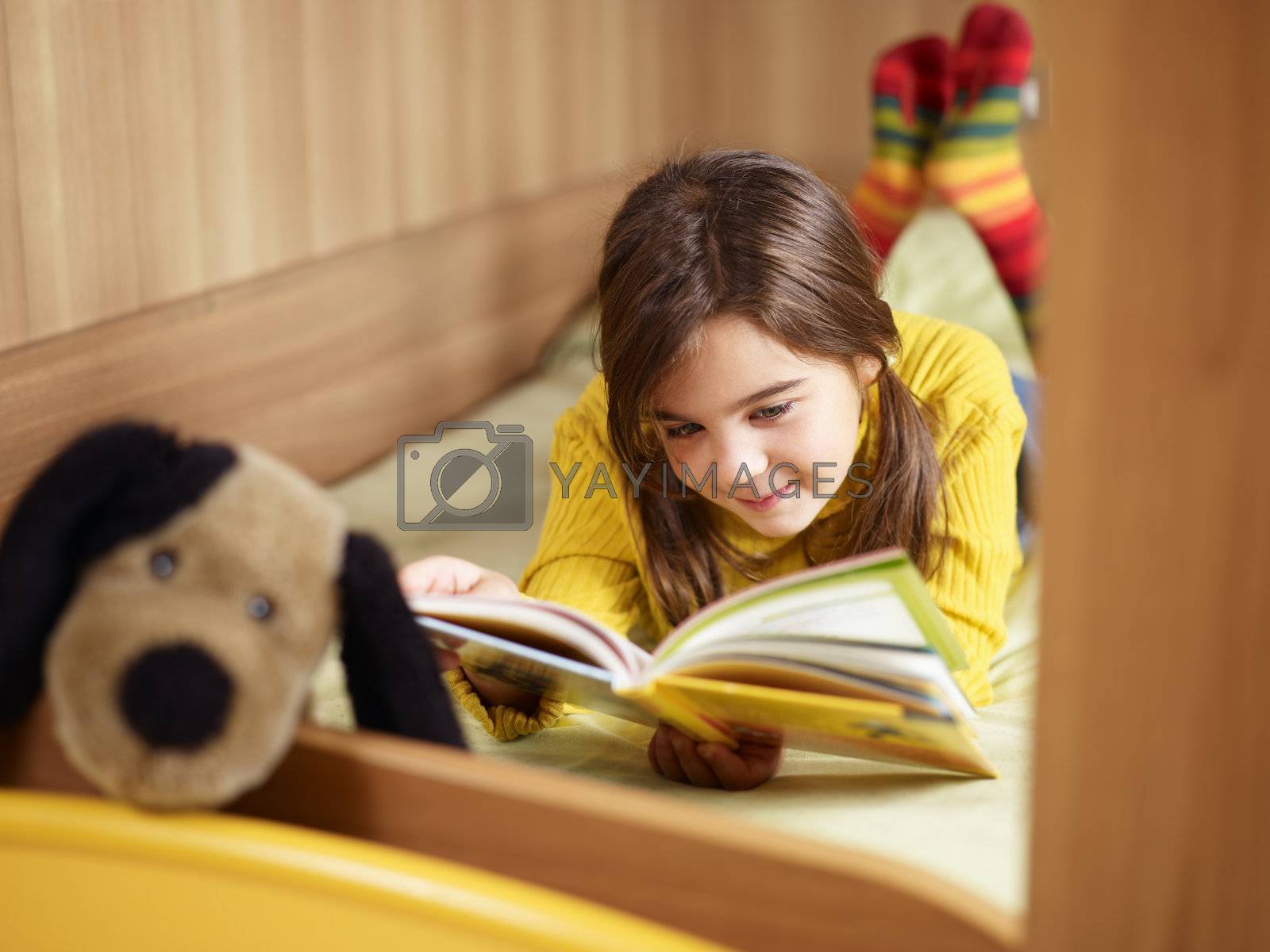Royalty free image of girl reading book  by diego_cervo