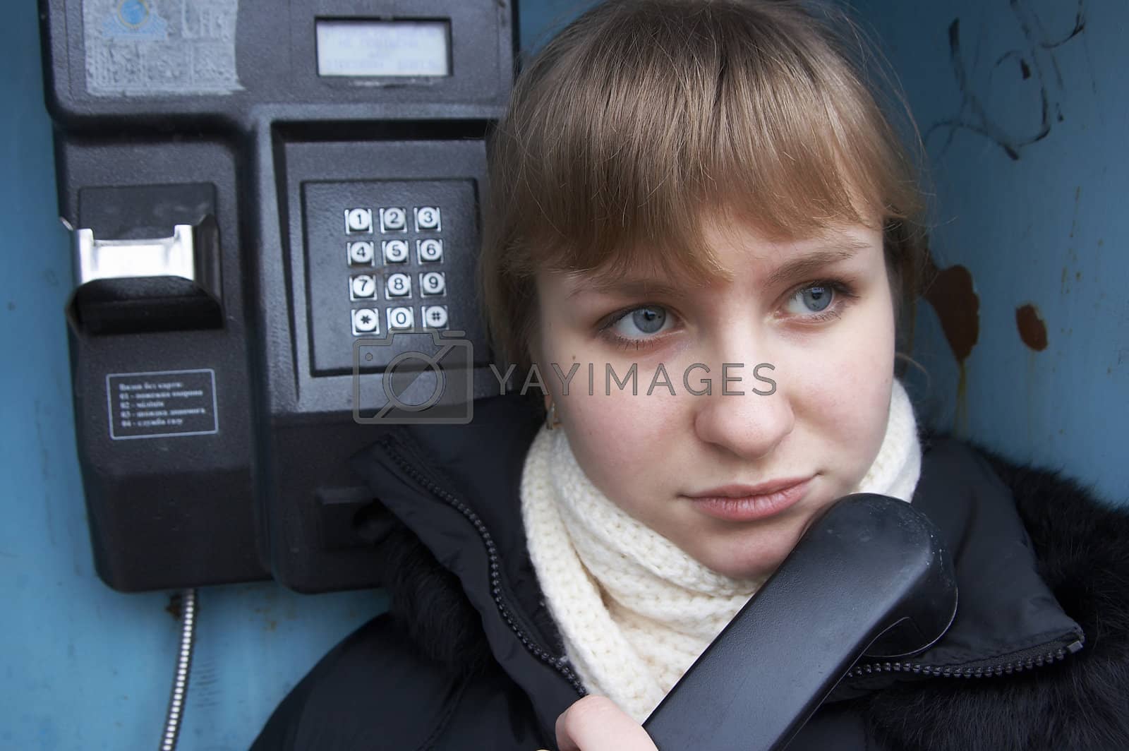Royalty free image of Upset girl with street phone by fotosergio
