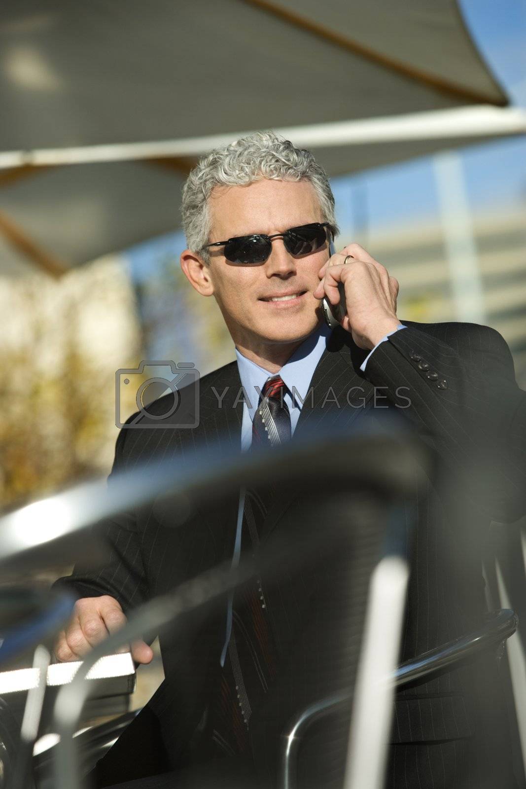 Royalty free image of Businessman on cellphone. by iofoto