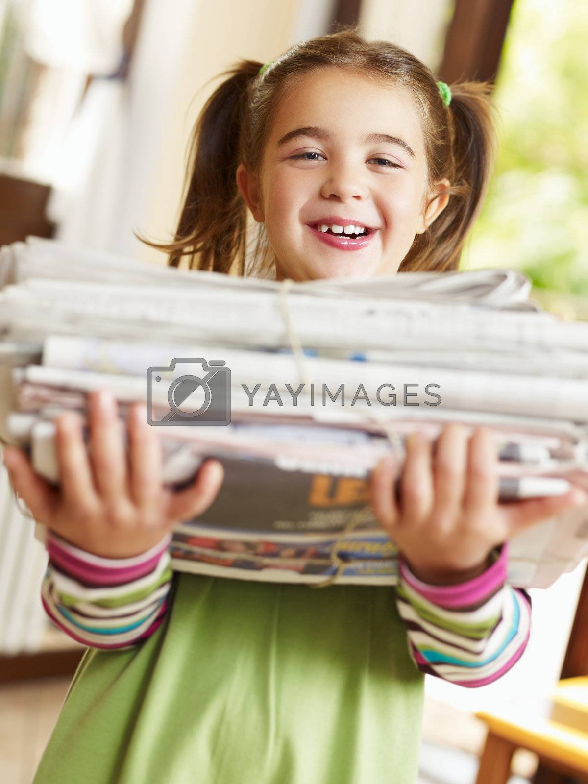 Royalty free image of girl recycling newspapers by diego_cervo