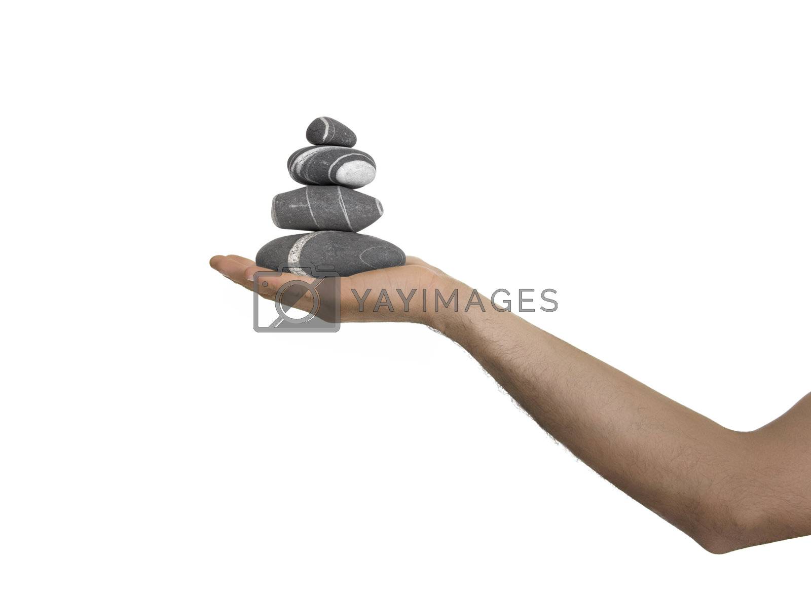 Royalty free image of Balanced stones on a man Hand by Iko