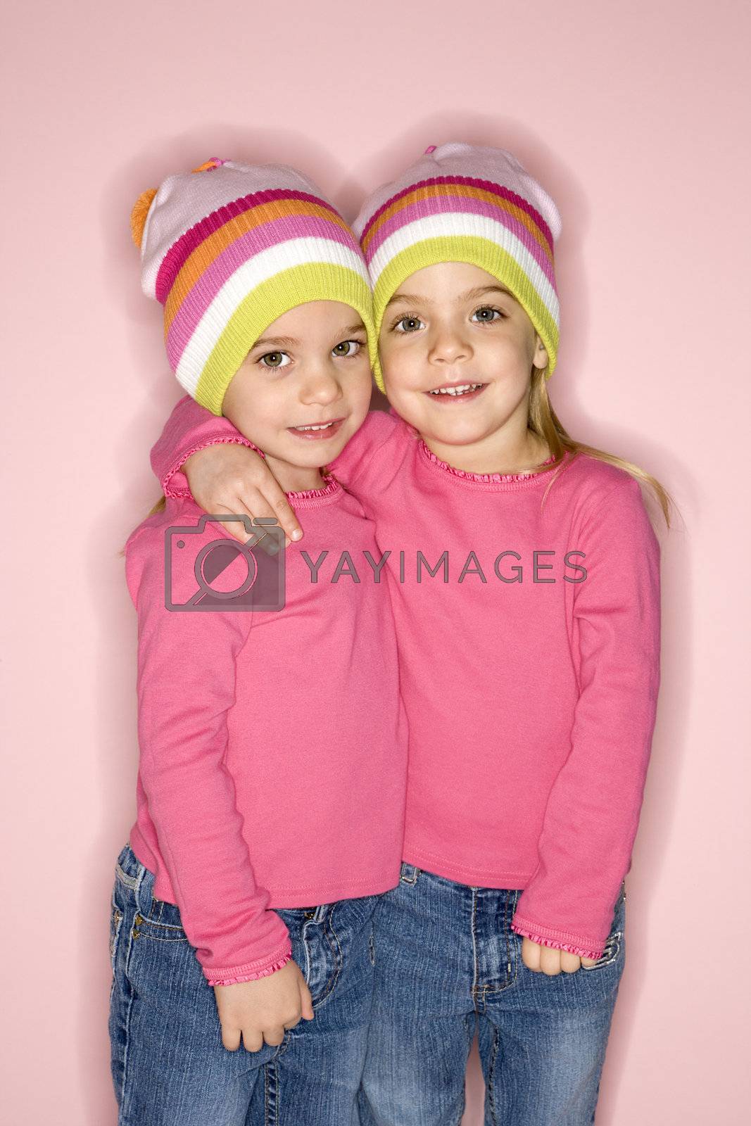 Royalty free image of Female twin children standing together. by iofoto