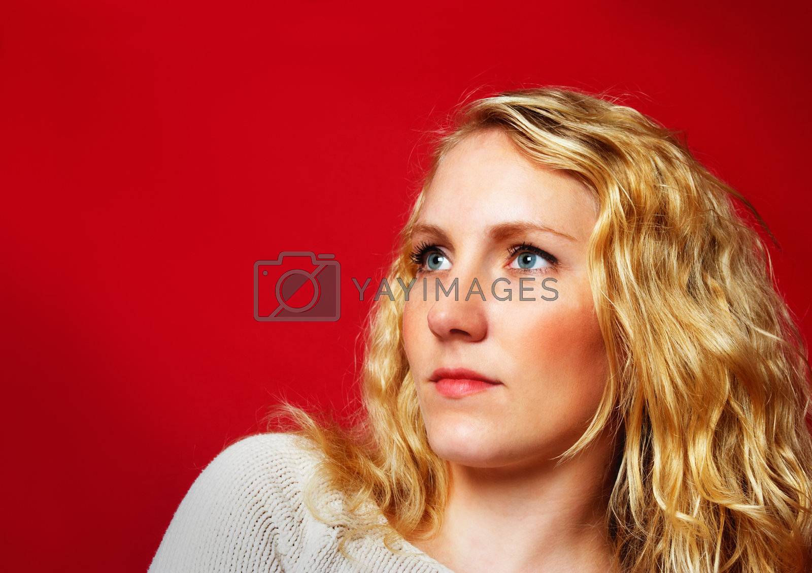 Royalty free image of Pretty blond girl on red by MikLav