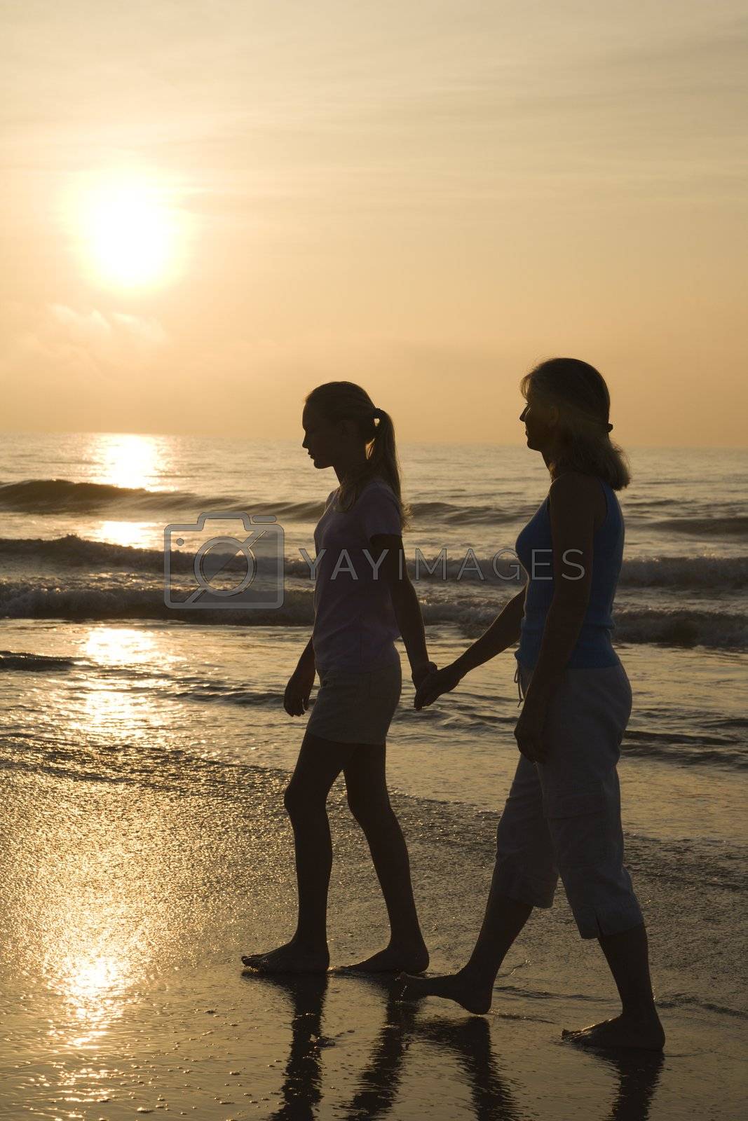 Royalty free image of Mom and daughter at sunrise. by iofoto