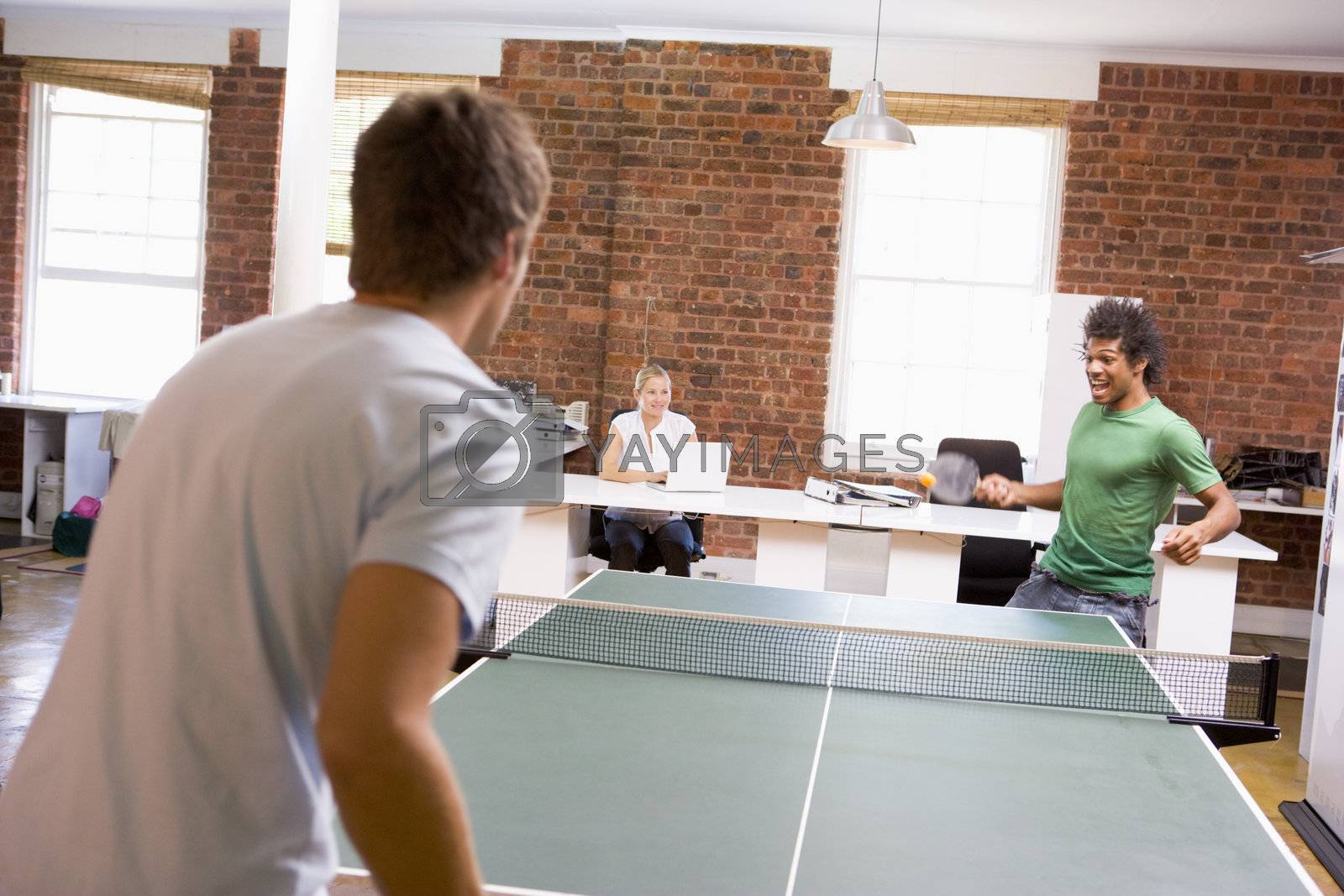 Royalty free image of Two men in office space playing ping pong by MonkeyBusiness