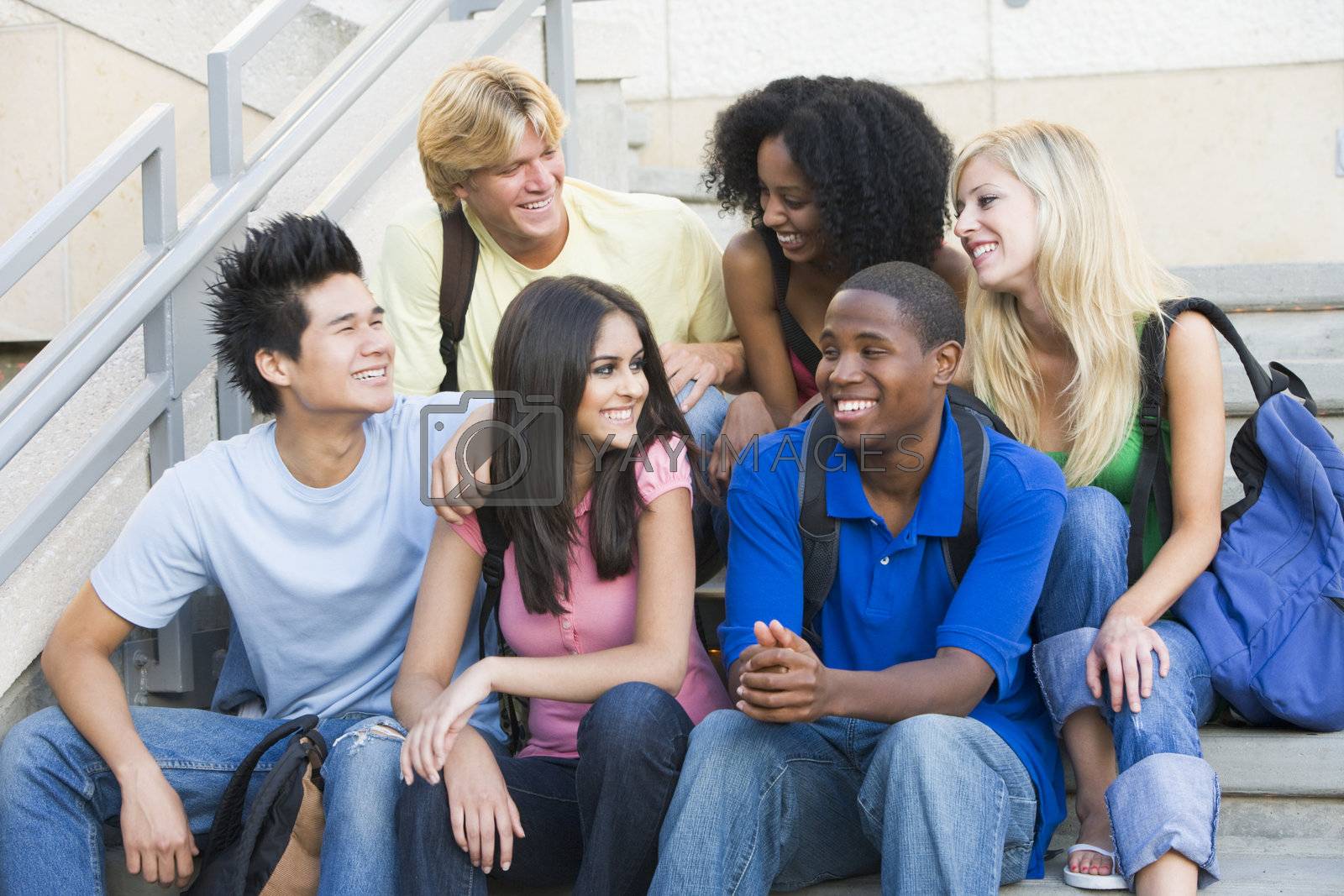 Royalty free image of Group of university students sitting on steps by MonkeyBusiness