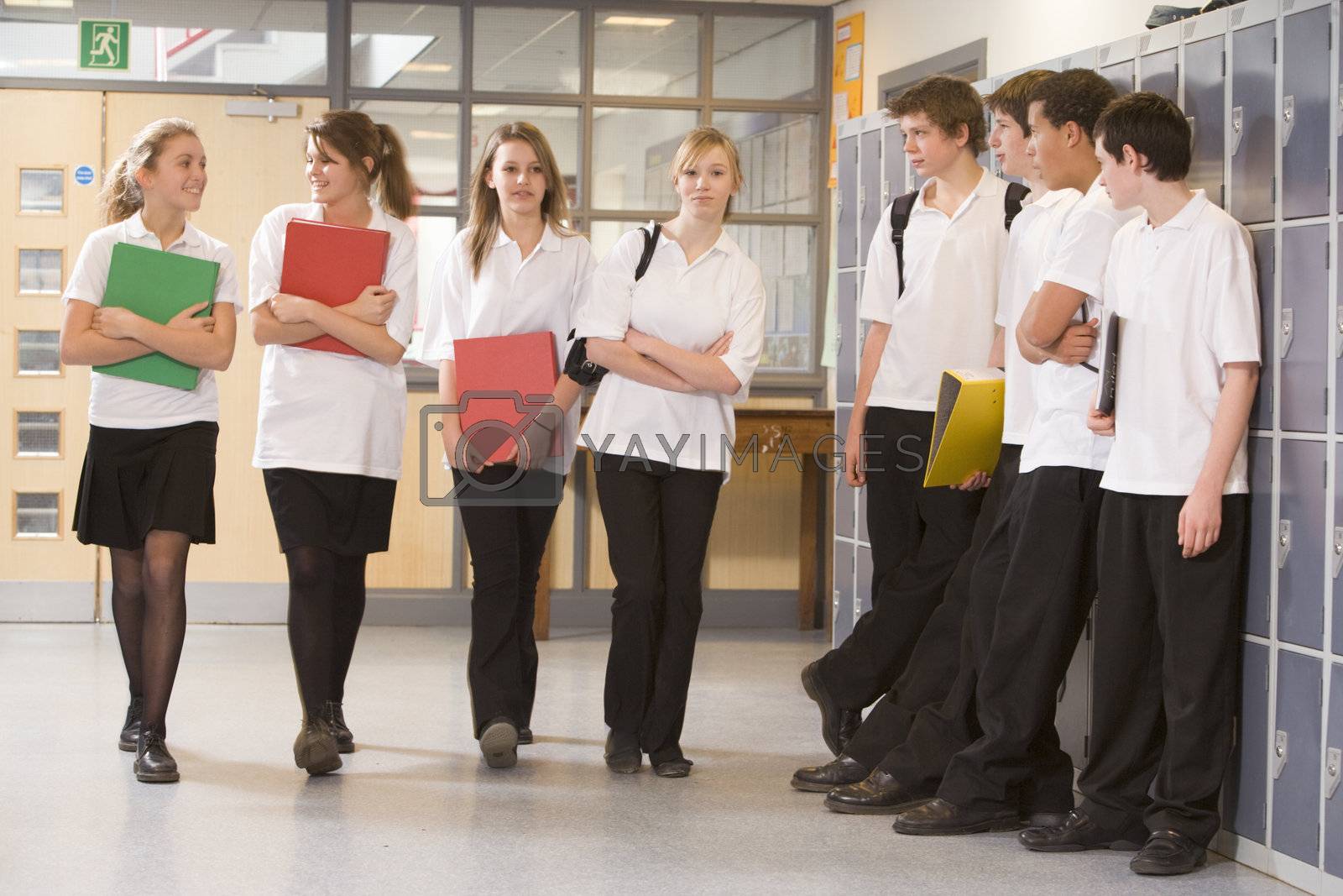 Royalty free image of Secondary school students in a school hallway  by MonkeyBusiness