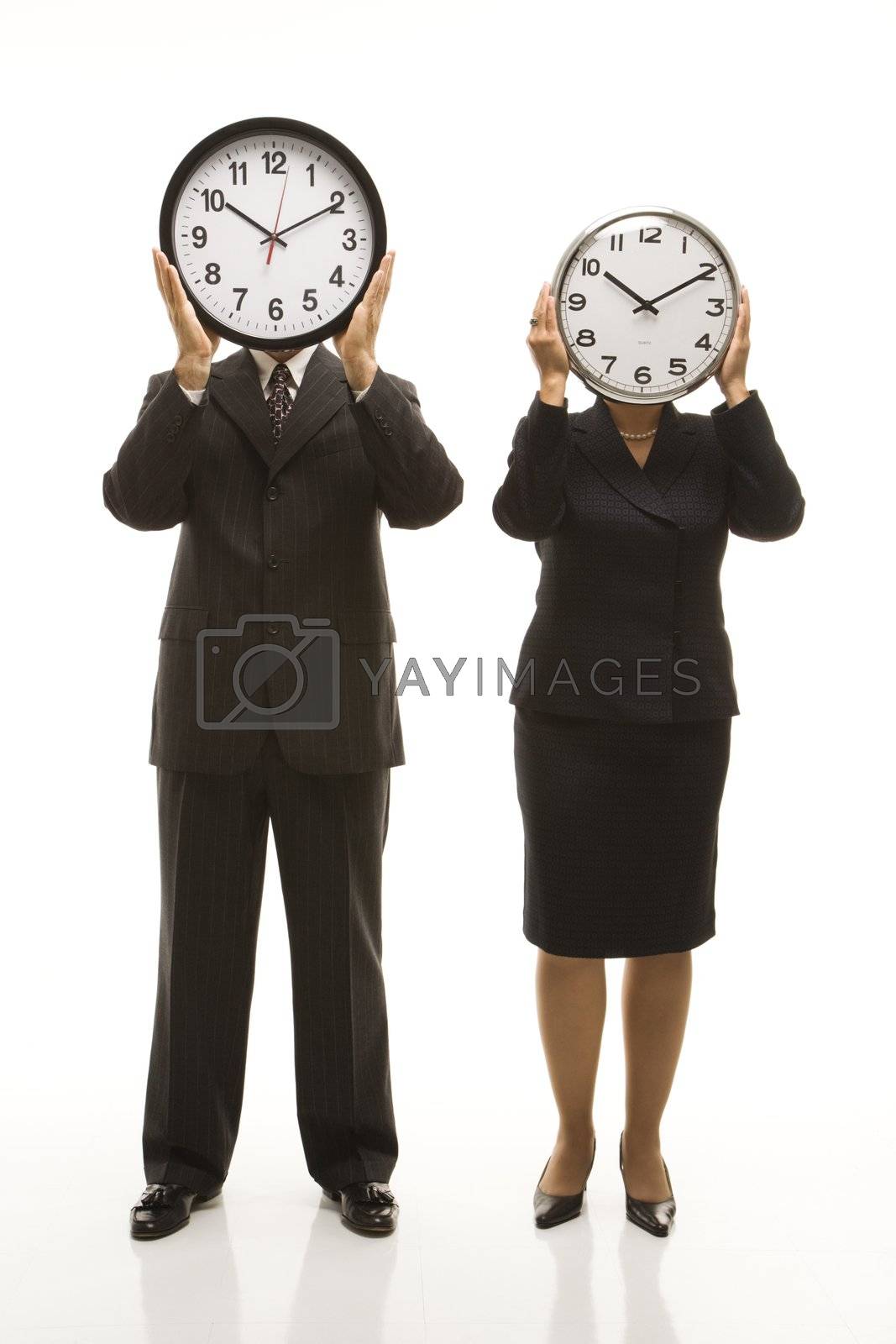 Royalty free image of Businesspeople holding clocks. by iofoto